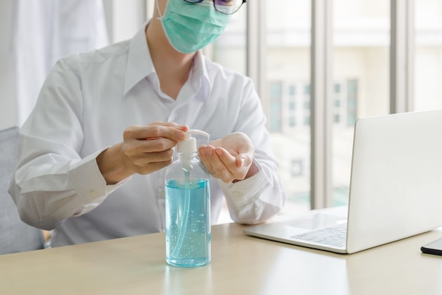 Businessman using antibacterial gel