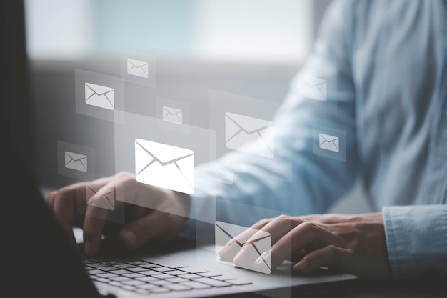 Businessman using computer laptop to send many email and business newsletter to customers for online digital marketing concept