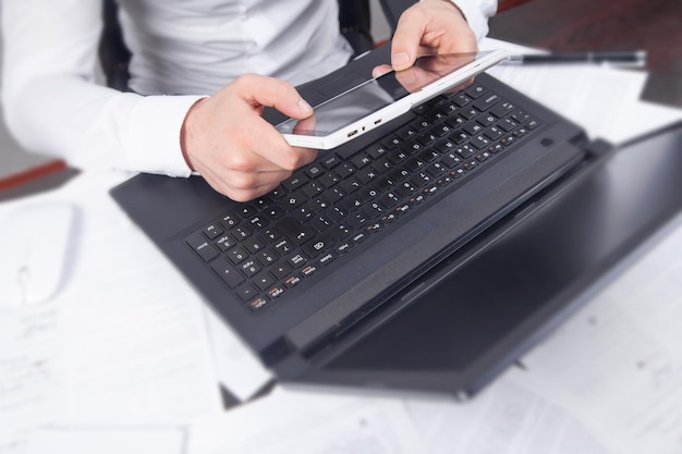 Businessman using his digital tablet in office