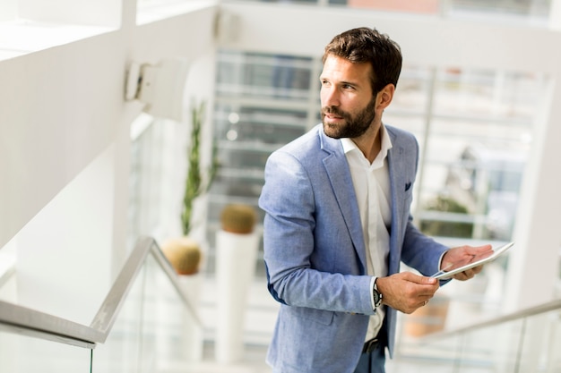 Businessman using his digital tablet at the office