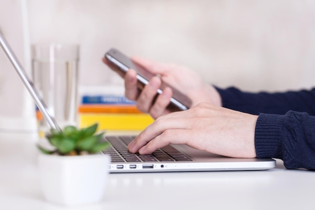 Businessman using laptop and mobile phone