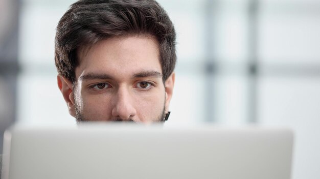 Businessman using a laptop while working late in his office