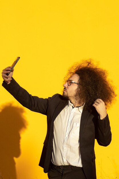 Businessman using a mobile phone taking a selfie