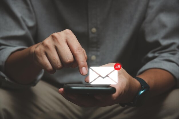 Businessman using smartphone with popup icon email and notification for business email and communication technology