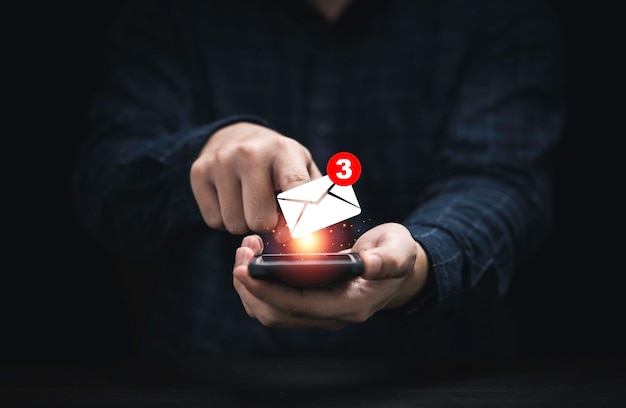 Businessman using smartphone with white newsletters and notification for business e-mail and business communication concept.