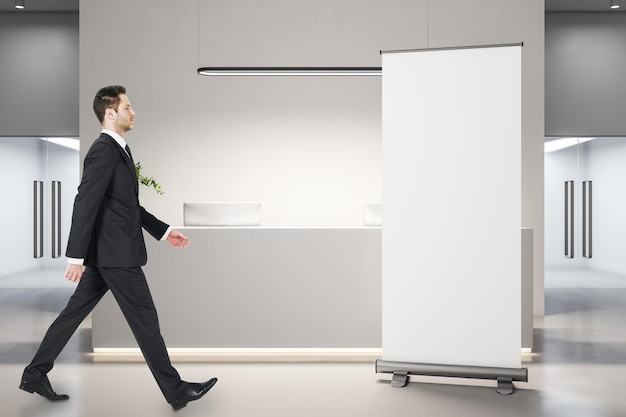 Businessman walking in modern office lobby interior