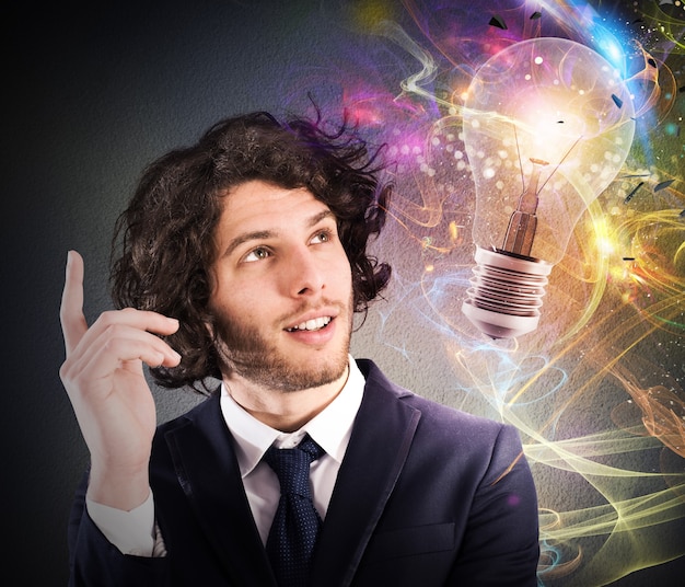 Businessman watching a light bulb drawn and thinks a new creative idea