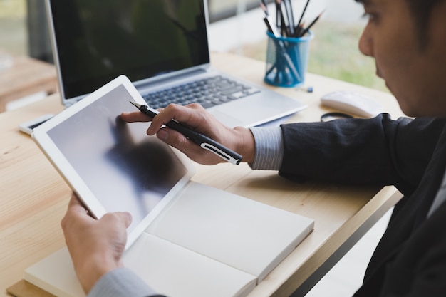 Businessman watching something on digital tablet in office