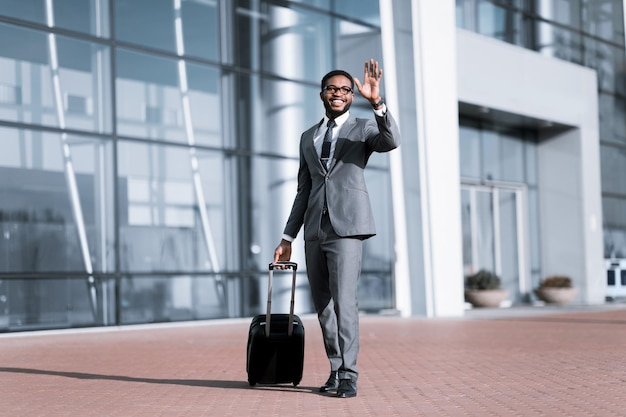 Businessman Waving a Taxi Cab In Public Transportation Station