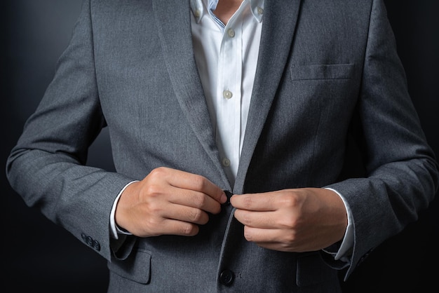 Businessman wearing a black gray suit on black background