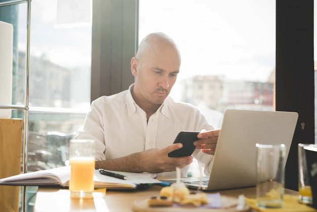 Businessman in white shirt working on office table