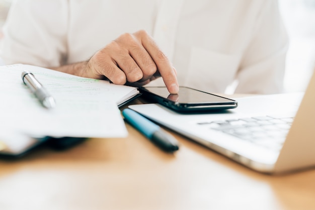 Businessman in white shirt working on office table