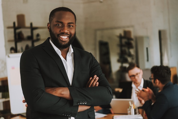 Businessman with Arms Crossed is Smiling.