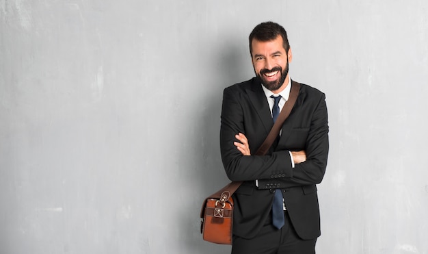 Businessman with beard keeping the arms crossed while smiling