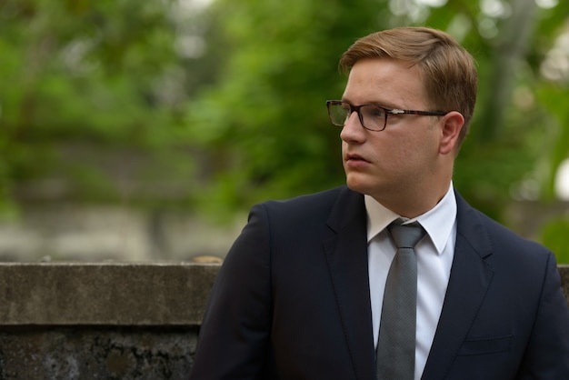 Businessman with blond hair in the streets outdoors