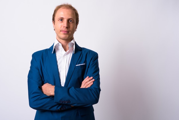 businessman with blond hair wearing blue suit against white space