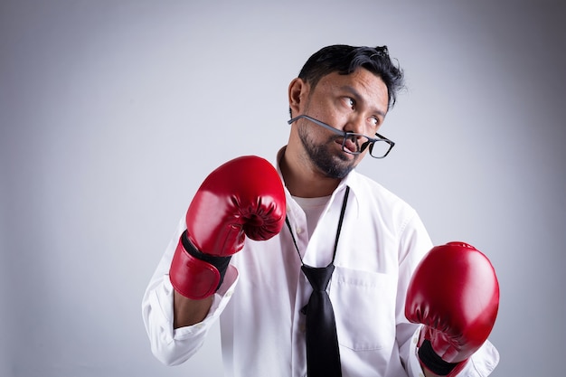 Businessman with boxing gloves ready to fight