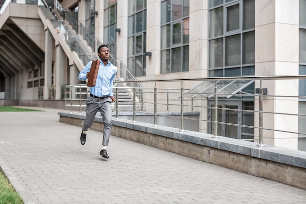 Businessman with briefcase running 