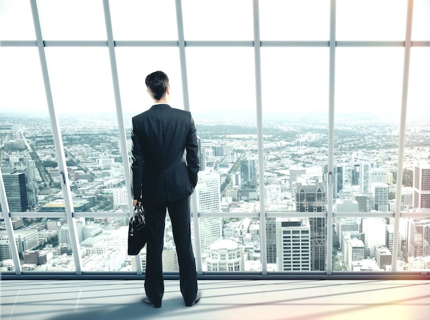 Businessman with case standing in office