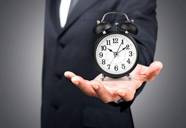 Businessman with clock in time concept on background