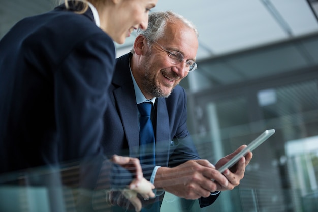 Businessman with colleague using digital tablet