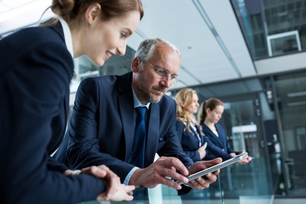 Businessman with colleague using digital tablet