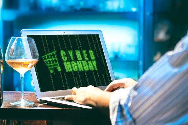 Businessman with Cyber Monday advert on the laptop screen on the desk