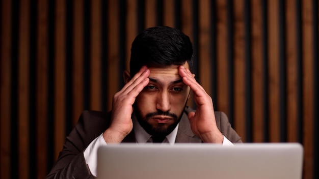 Businessman with hands behind head resting in comfortable office