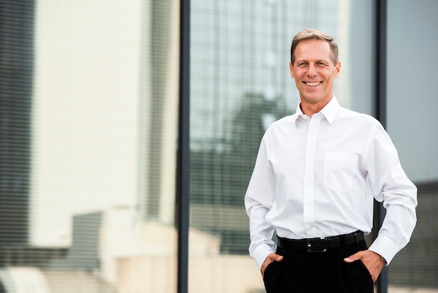 Businessman with hands in pockets looking at camera