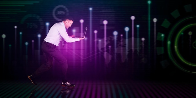 Businessman with laptop running with technology background