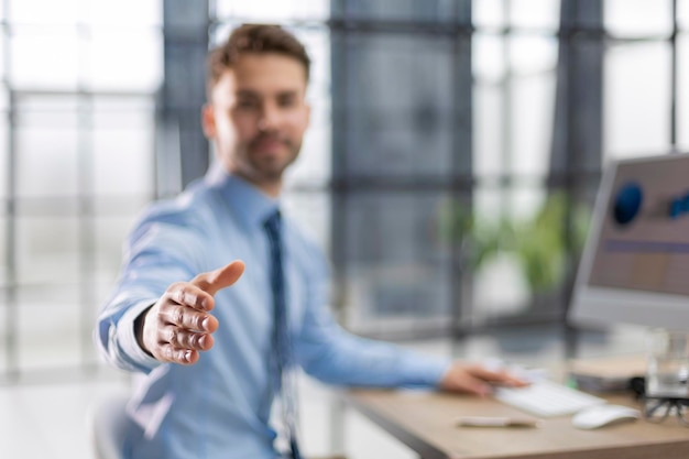 Businessman with an open hand ready to seal a deal