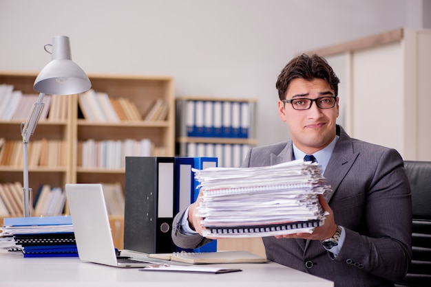 Businessman with too much paperwork