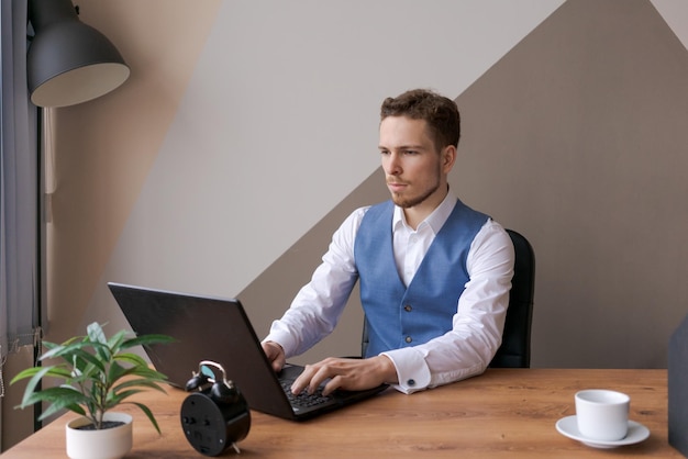 Businessman at work Man working on laptop while sitting at wooden table