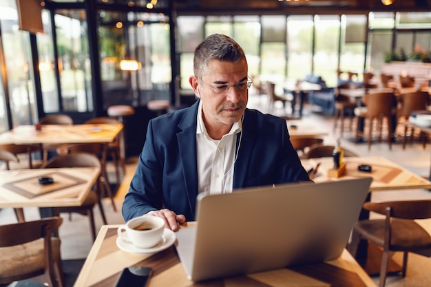 Businessman working in cafe.