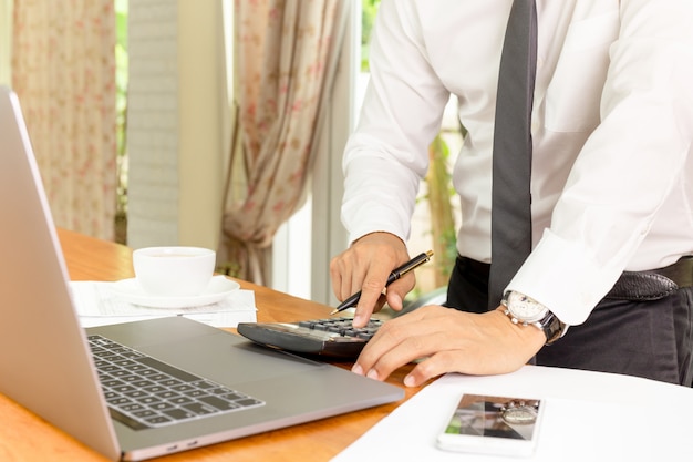 Businessman working on calculator to calculate financial plan