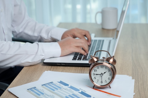 Businessman working at the desk against time