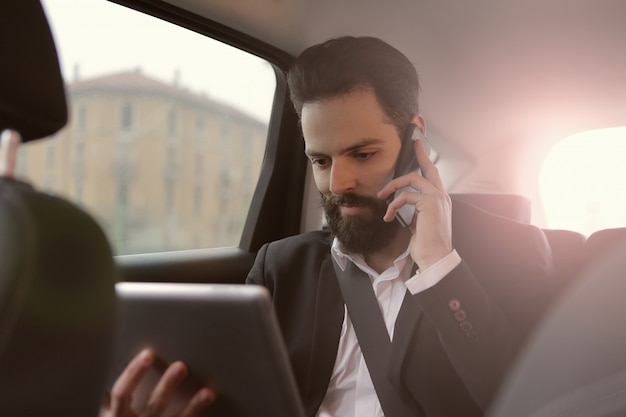 Businessman working from a car