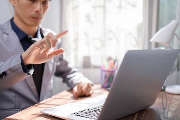 Businessman working in front of a notebook computer at a desk