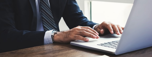 Businessman working on laptop computer at office 