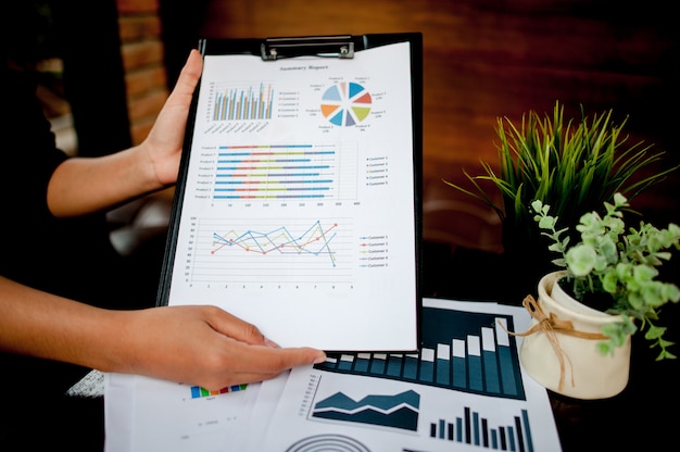 Businessman working at the office And graphs on his desk. Business concept And copy space