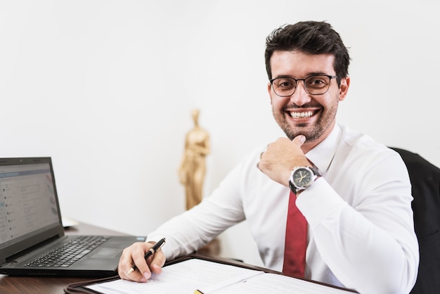 Businessman working in office with laptop and documents on his desk, consultant lawyer concept.