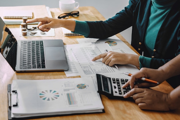 Businessman working in office with using a calculator to calculate the numbers finance accounting concept