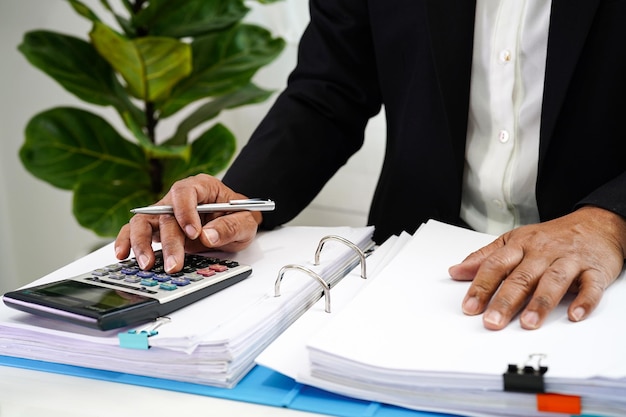 Businessman working and prepare paperwork report data to analysis information in file binder at office