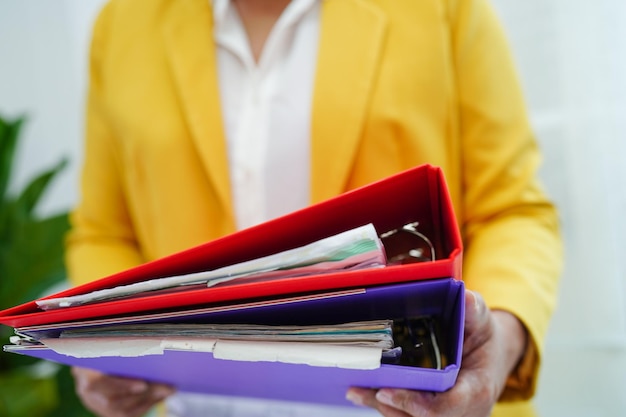 Businessman working and prepare paperwork report data to analysis information in file binder at office