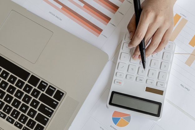 Businessman working in a private office, she is reviewing the company's financial documents sent from the finance department before he takes it to a meeting with a business partner. Financial concept.