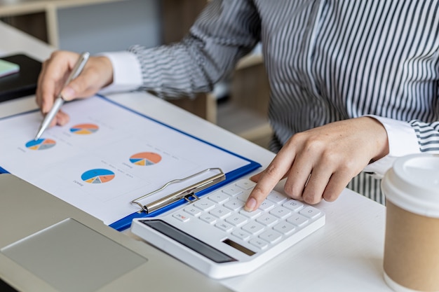 Businessman working in a private office, she is reviewing the company's financial documents sent from the finance department before he takes it to a meeting with a business partner. Financial concept.