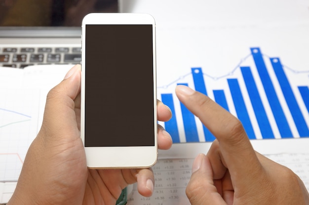 Businessman working with blank screen smartphone at office.