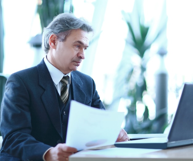 Businessman working with business documents sitting at his Desk. photo with copy space