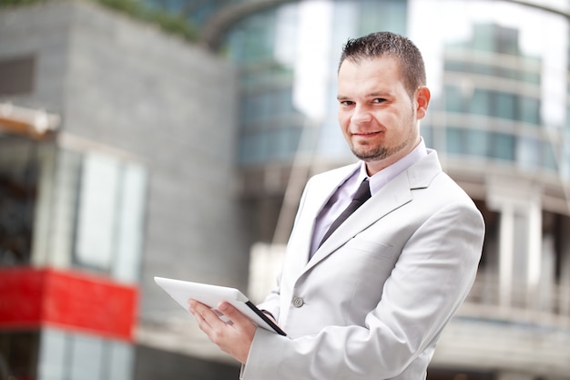 Businessman working with digital tablet in urban city