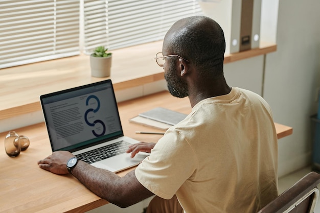 Businessman working with documents on laptop